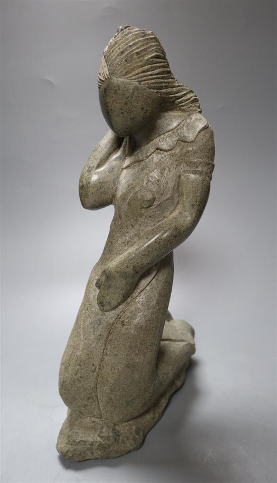 A carved mineral figure of a kneeling female, 32cm